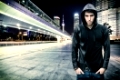 Gorgeous Young Man in Trendy Hooded Shirt Standing at the City Street While Looking at the Camera.